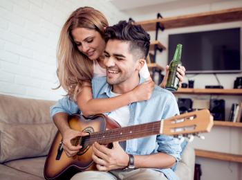 Stel met gitaar op de bank